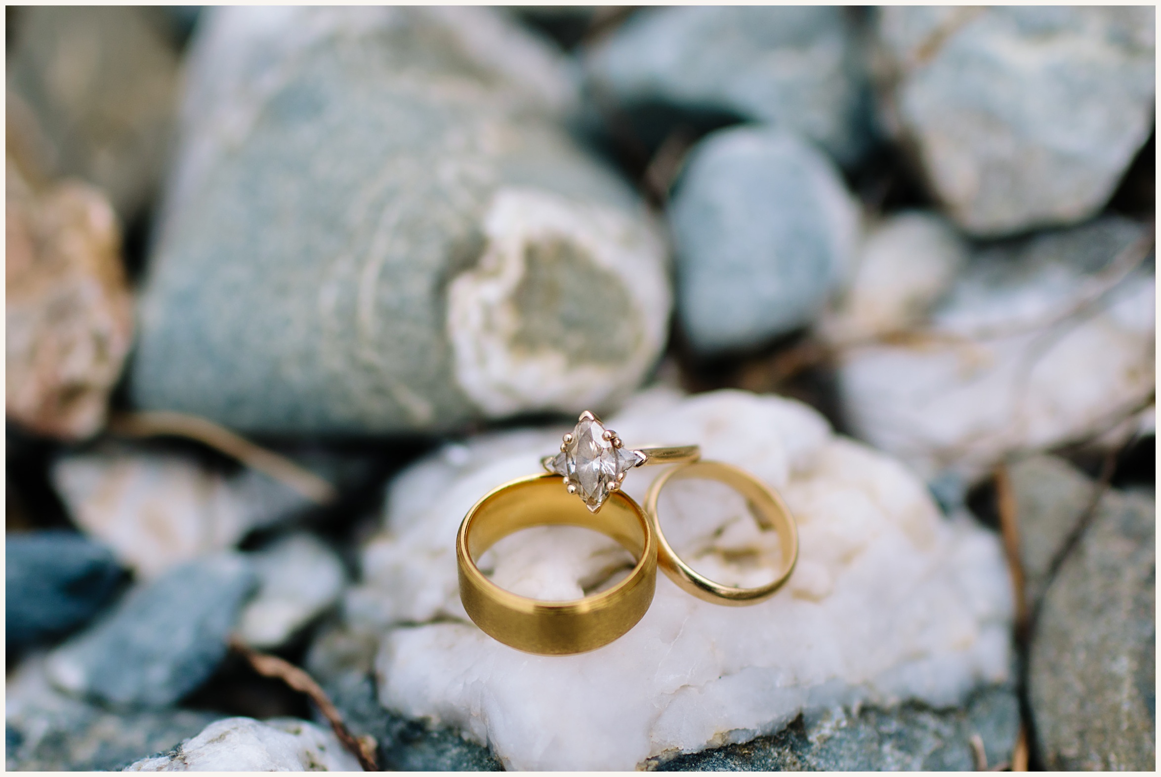 Photo of Wedding Ring set on beach rocks