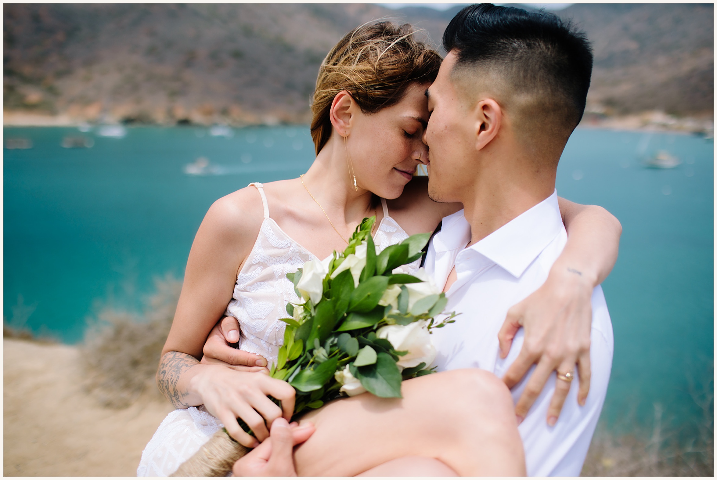 Photo of bride and groom with backdrop of cliffside view