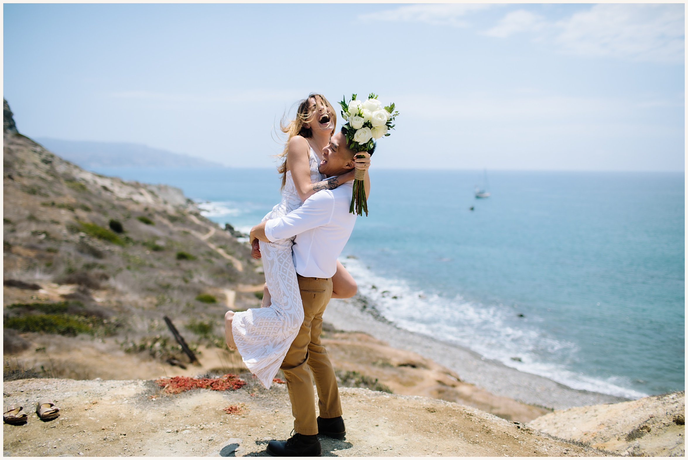 Photo of bride and groom with backdrop of cliffside view