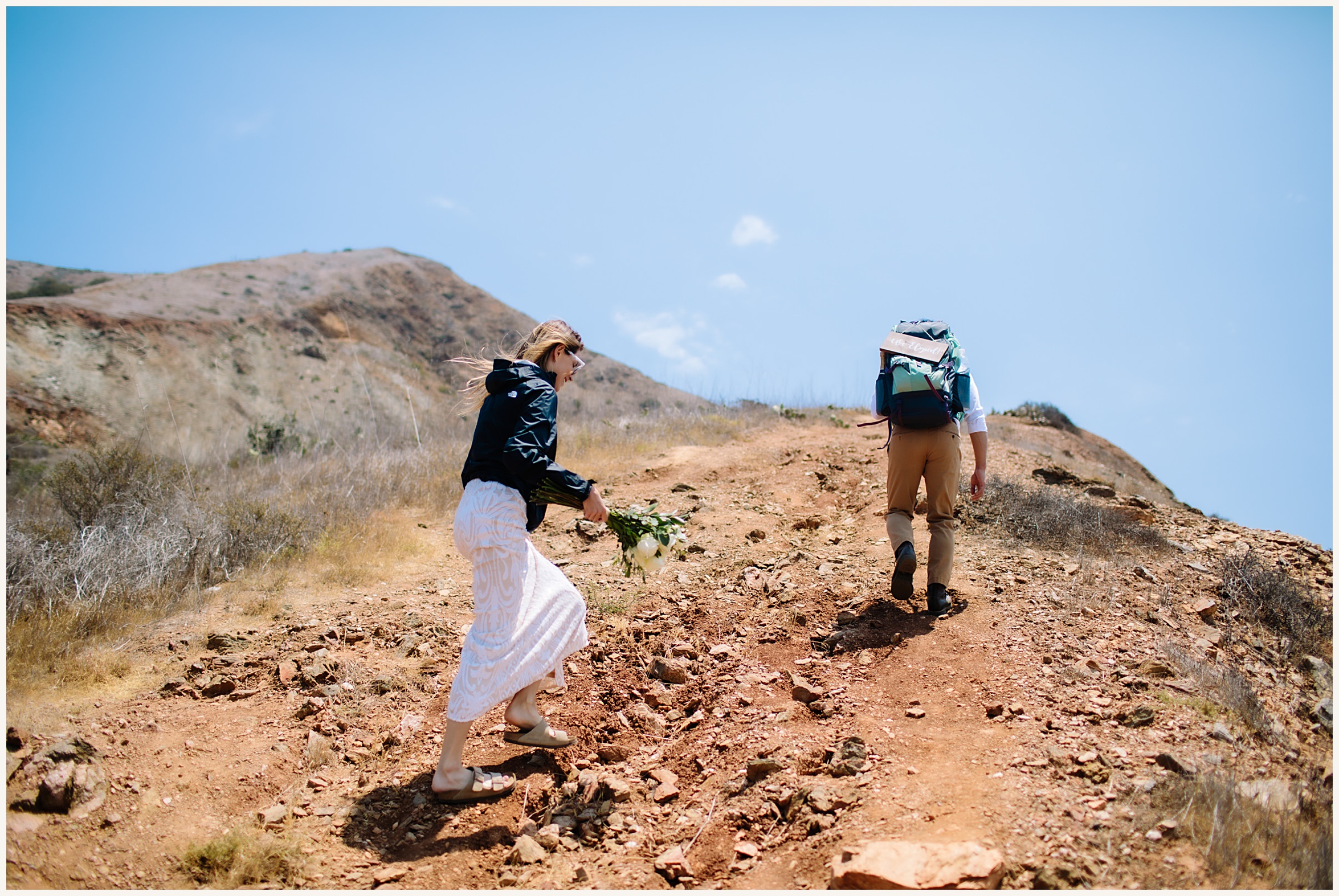Photo of bride and groom hiking up Catalina Island Trail