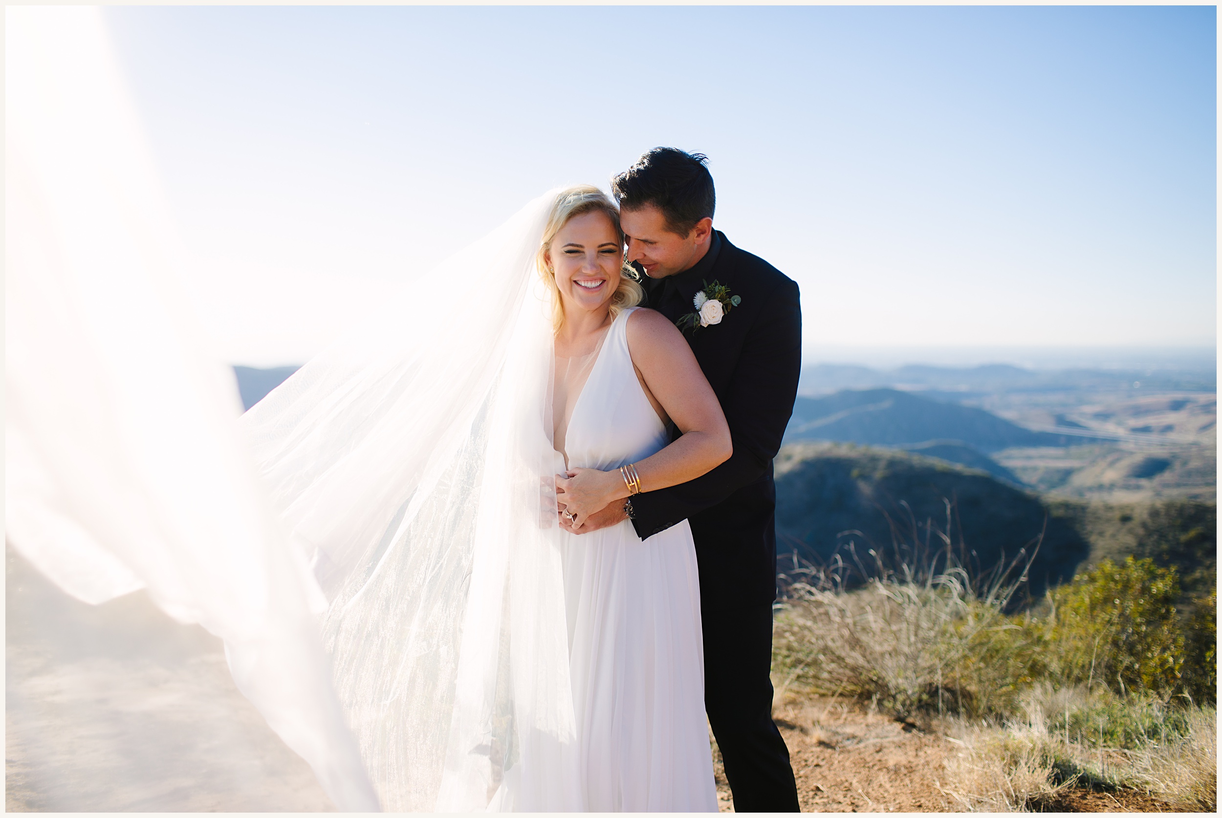 Photo of bride and groom on cliffside view