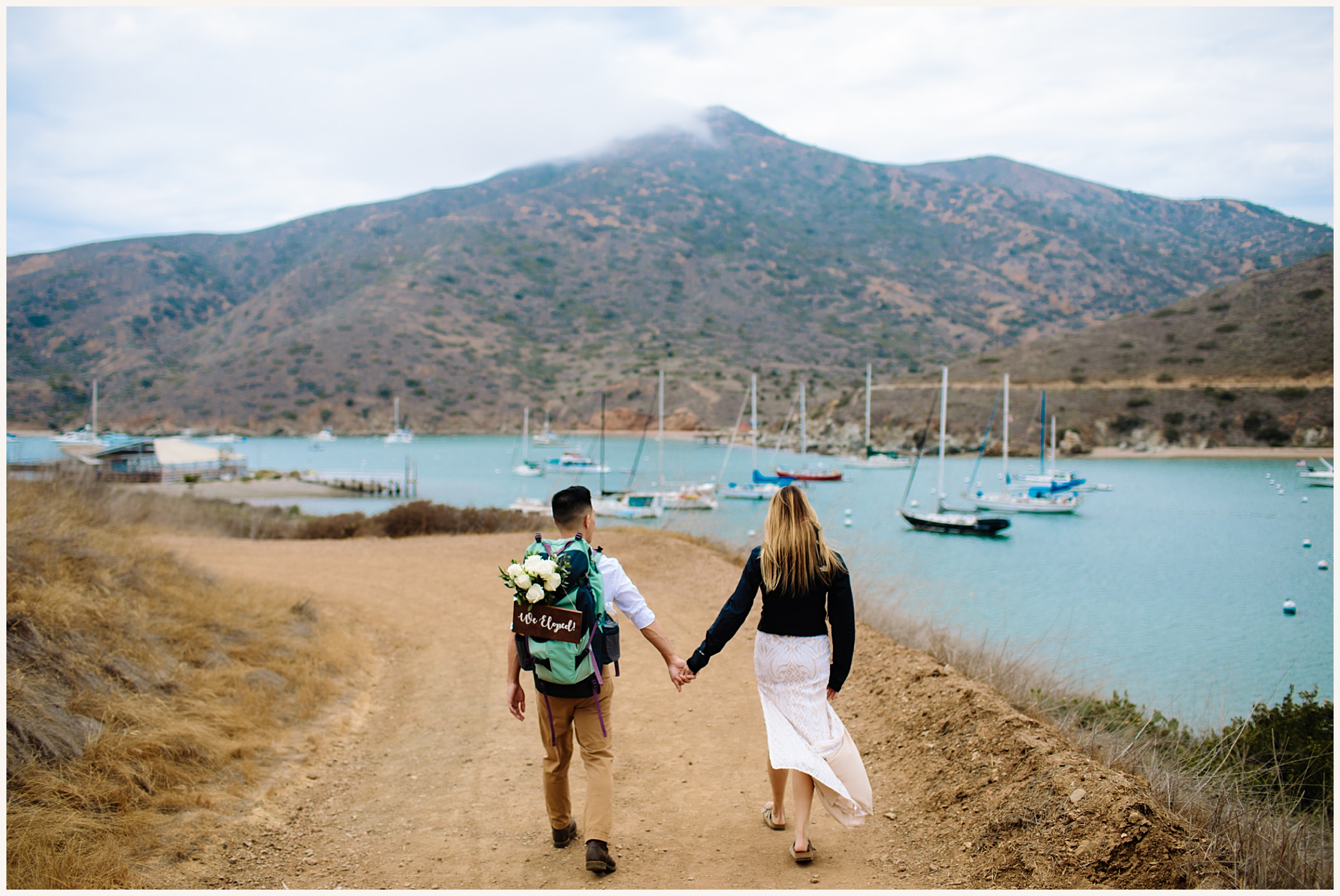 Photo of bride and groom hiking on Catalina Island Trail