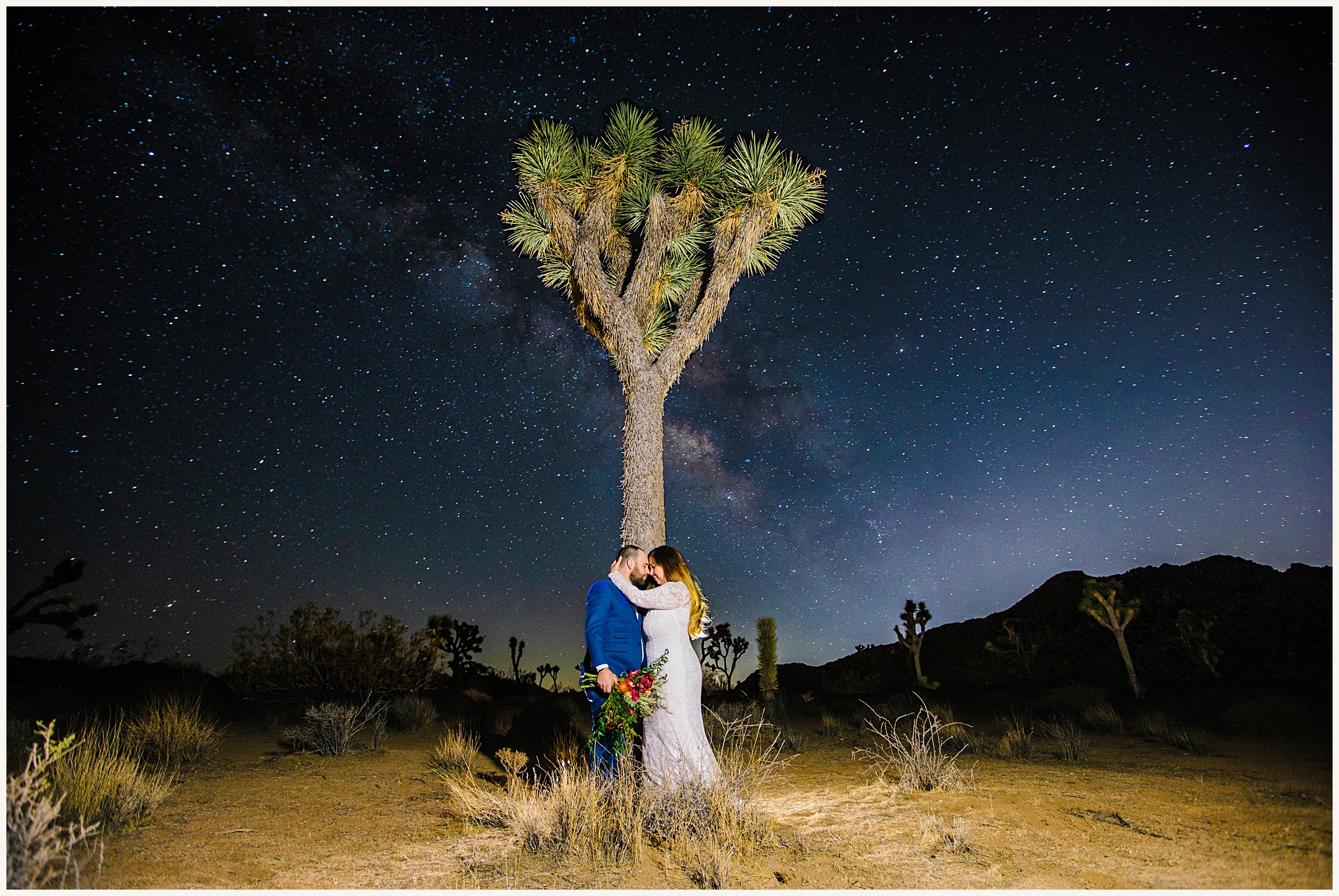 Photo of bride and groom in Joshua Tree at night with Milky Way sky