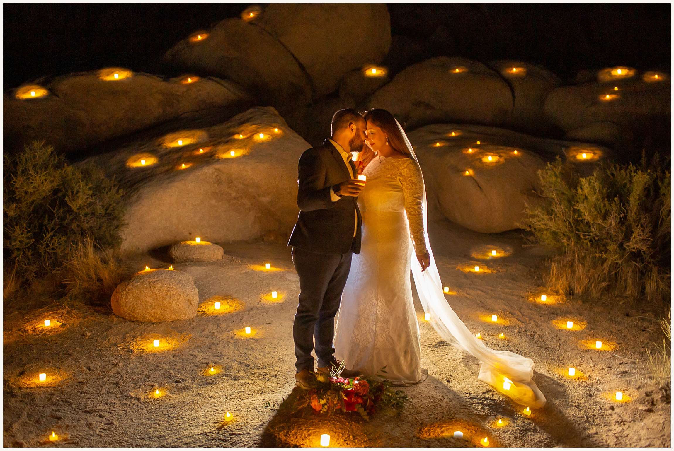Photo of bride and groom in Joshua Tree at night with candles lit up