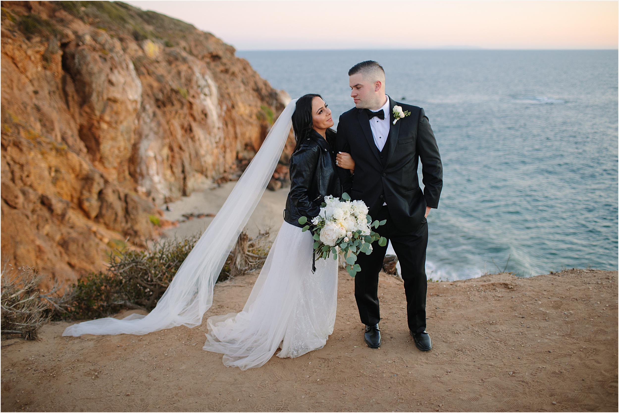 Photo of bride and groom on cliffside view in Malibu during their Malibu beach elopement