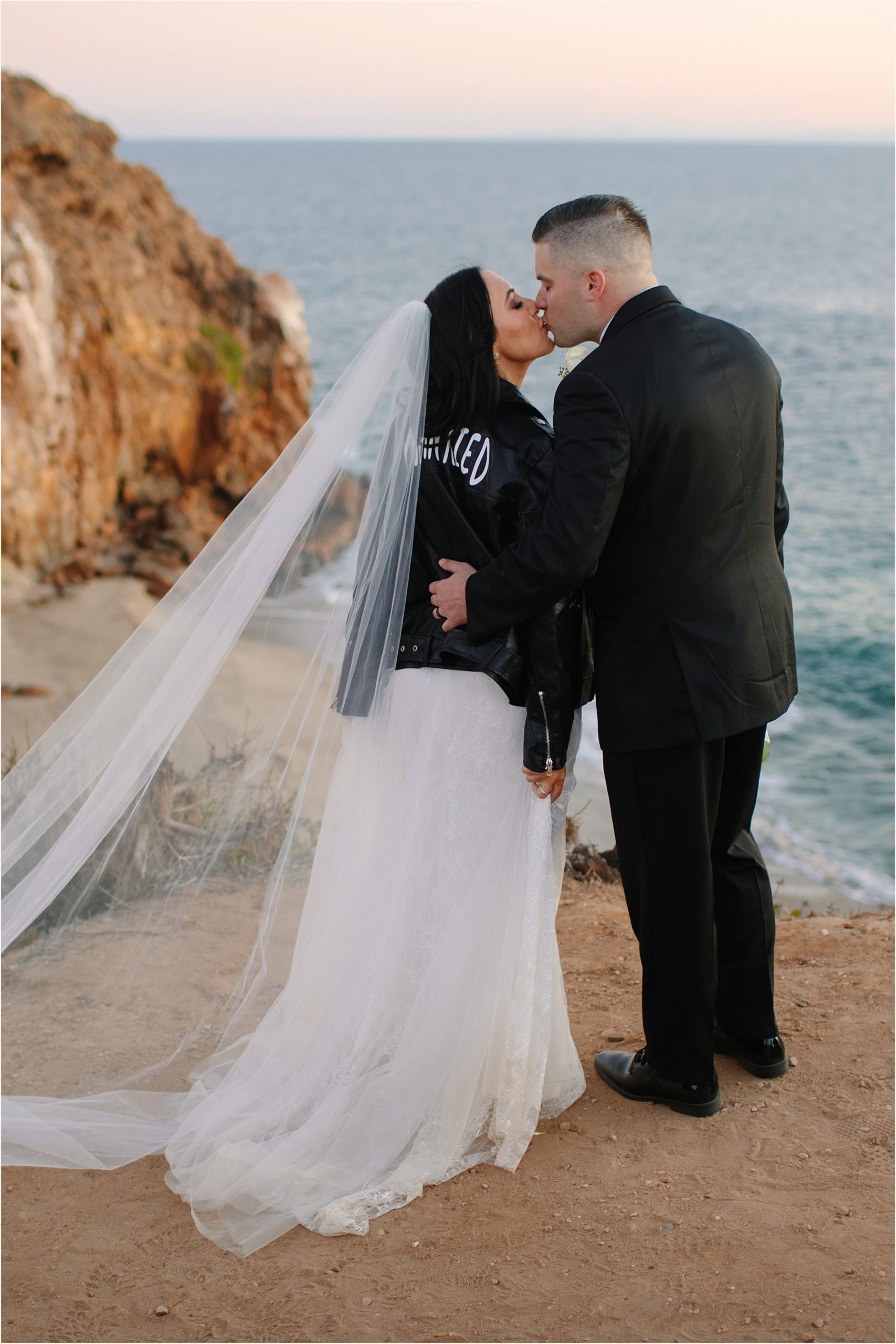 Photo of bride and groom during their Malibu beach elopement on cliffside view 
