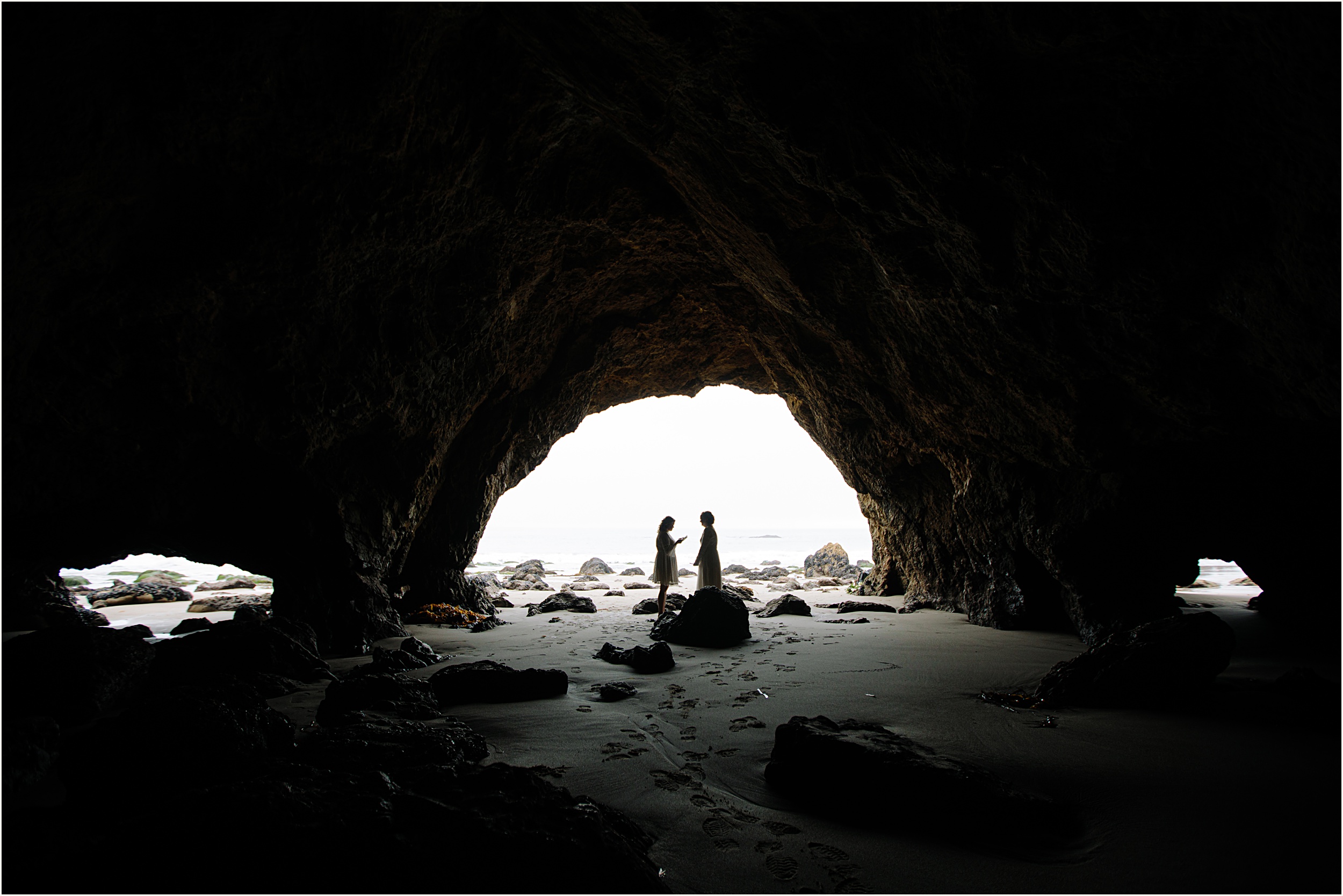 Photo of brides in El Matador beach cave exchanging vows