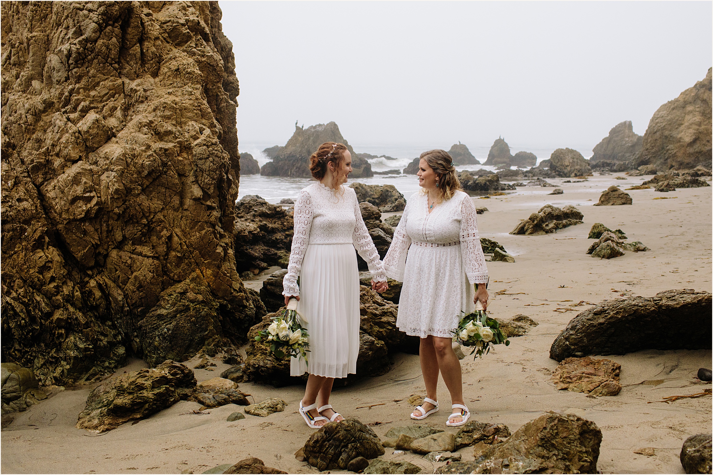 Photo of brides in stunning white lace elopement dresses at El Matador beach